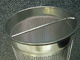 Reusable stainless steel fine mesh filter basket for industrial liquid filtration.